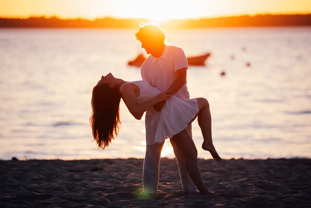 Couple dancing on the beach at sunset